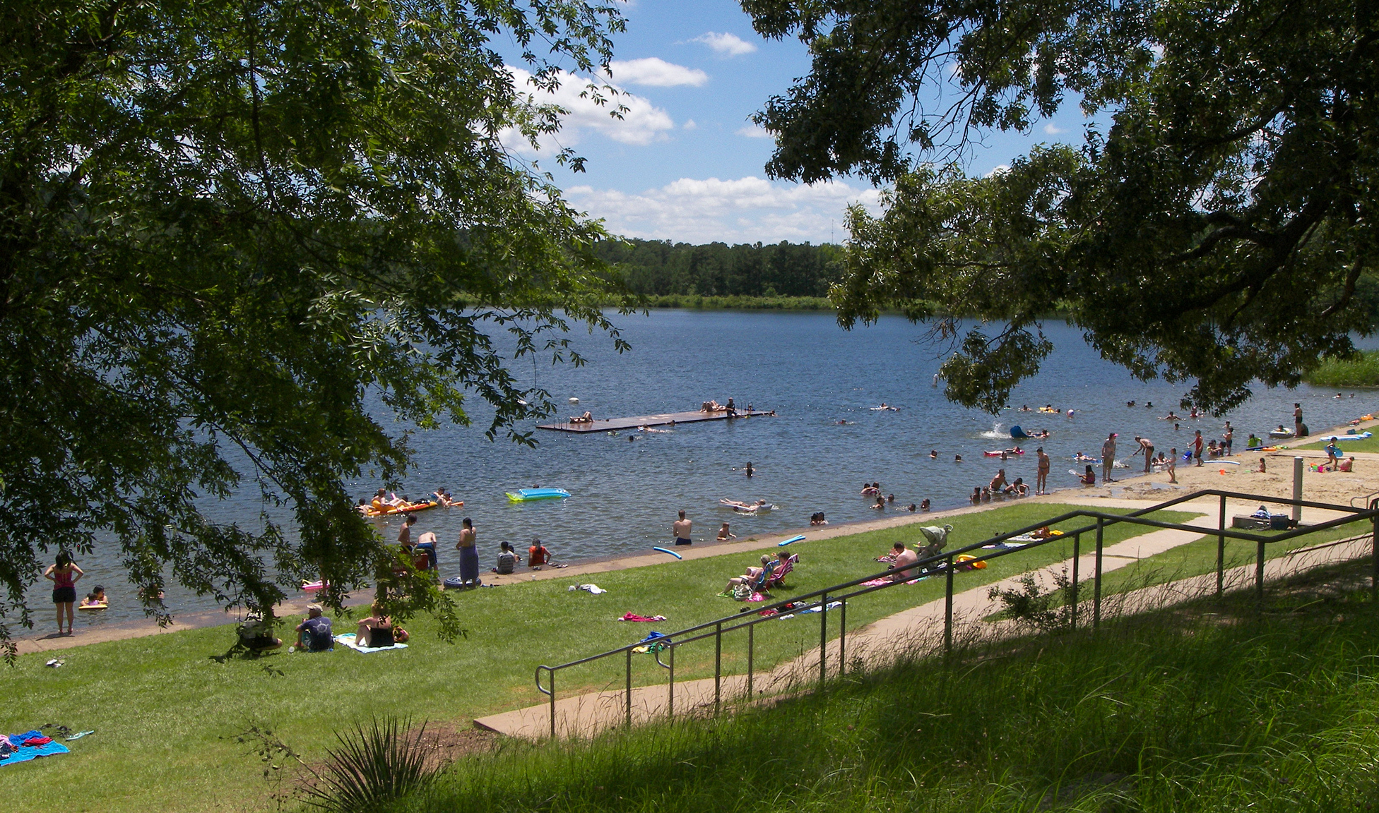The actual lake and swimming area at Tyler State Park in East Texas, shaded by trees.
